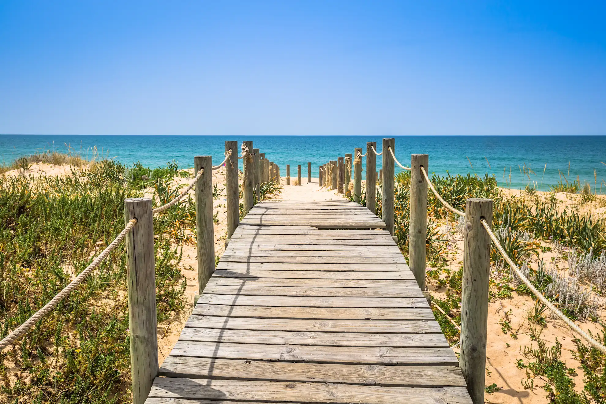 Algarve Beaches often have long wooden board walk like the Praia de Faro